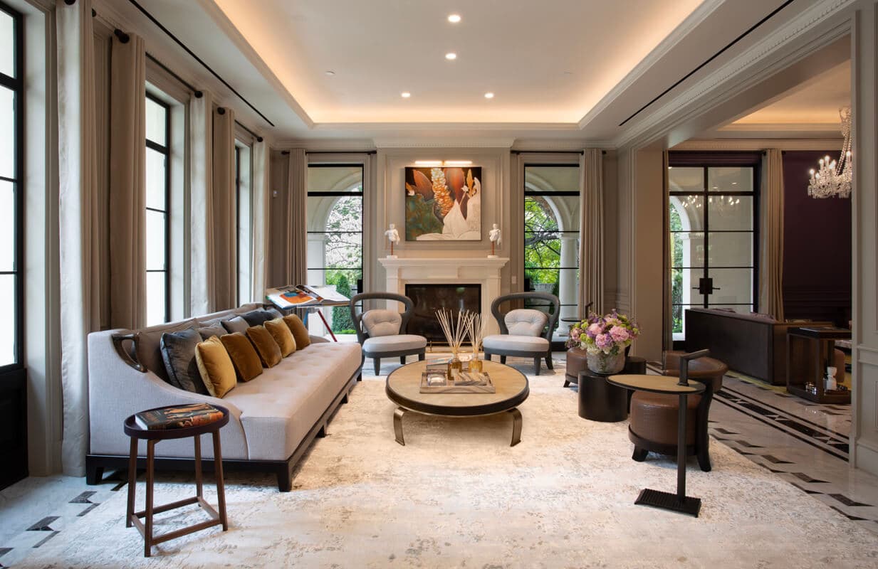 Formal living room with warm cove lighting and a clean ceiling