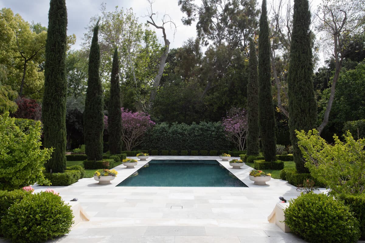 Pool and spa framed by Italian cypress in the estate garden